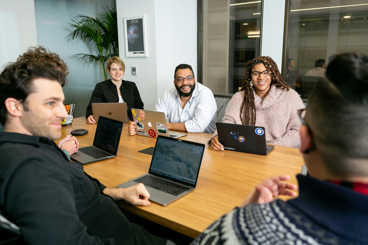 A group of coworkers on a RevOps team collaborate in a meeting room.